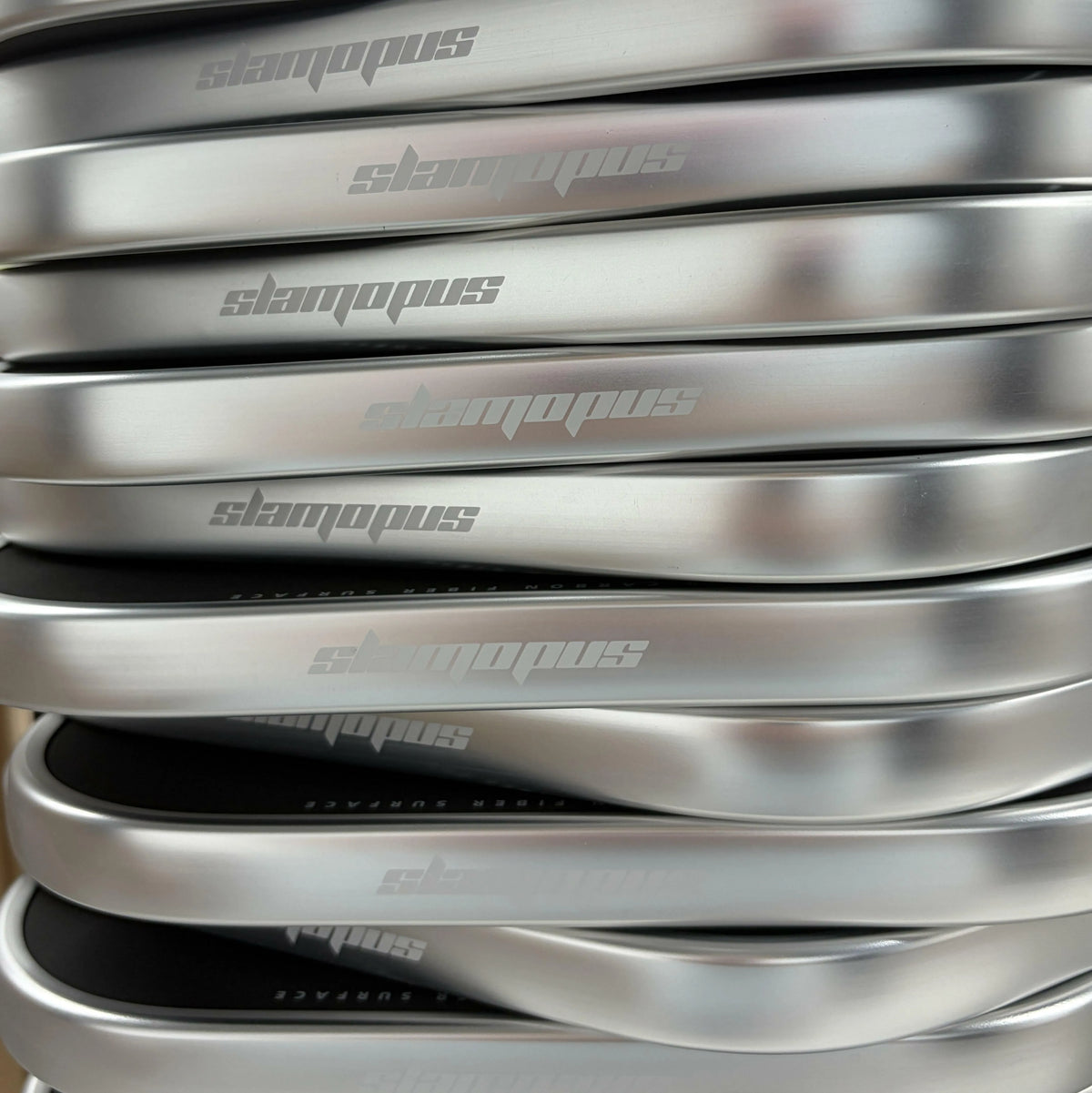 Close-up of custom silver pickleball paddle edge guards with printed logos.