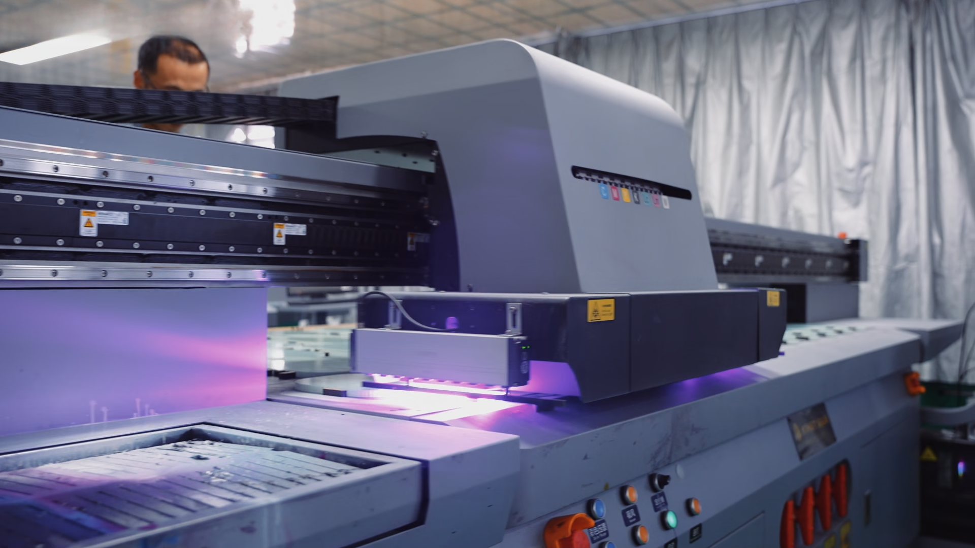 UV printing machine applying graphics to pickleball paddles during manufacturing