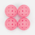 Four pink perforated balls on a white background