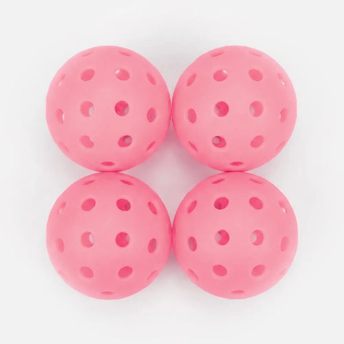 Four pink perforated balls on a white background